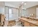 Bathroom featuring a vanity with marble countertop, ample storage, and a shower with glass doors for a luxurious feel at 119 Carlyle Cir, Palm Harbor, FL 34683
