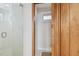 Bright bathroom features a glass shower with white tiled walls and a window allowing natural light at 119 Carlyle Cir, Palm Harbor, FL 34683