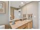 Bathroom featuring a marble countertop vanity, offering an elegant space with ample lighting and storage at 119 Carlyle Cir, Palm Harbor, FL 34683