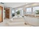 Bathtub with a bay window showing waterfront views, marble countertops, and tile flooring at 119 Carlyle Cir, Palm Harbor, FL 34683