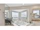 Bathtub with a bay window showing waterfront views, marble countertops, and tile flooring at 119 Carlyle Cir, Palm Harbor, FL 34683