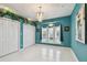 Bedroom with tile floors, teal walls, chandelier, and closet at 119 Carlyle Cir, Palm Harbor, FL 34683