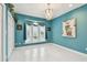 Bedroom with tile floors, teal walls, chandelier, and closet at 119 Carlyle Cir, Palm Harbor, FL 34683