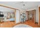 Spacious bedroom with hardwood floors, a ceiling fan, and multiple doorways leading to other rooms at 119 Carlyle Cir, Palm Harbor, FL 34683