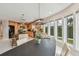 Bright dining area featuring an adjacent kitchen, bay windows, and waterfront views at 119 Carlyle Cir, Palm Harbor, FL 34683