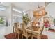 Elegant dining area with large windows, staircase, and views of the water and front entry at 119 Carlyle Cir, Palm Harbor, FL 34683