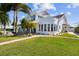Striking two-story home with modern design, well-manicured lawn and a paved walkway at 119 Carlyle Cir, Palm Harbor, FL 34683