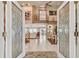 Inviting foyer with decorative glass doors, high ceilings, and staircase to the second floor and views to the water at 119 Carlyle Cir, Palm Harbor, FL 34683