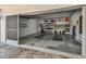 View of a garage with storage shelves and diamond-patterned floors at 119 Carlyle Cir, Palm Harbor, FL 34683