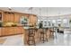 Gourmet kitchen boasting custom cabinets, granite countertops, and views of the water, and an open dining area at 119 Carlyle Cir, Palm Harbor, FL 34683