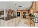 Spacious kitchen featuring wood cabinets, granite counters, and island with eat-in breakfast bar at 119 Carlyle Cir, Palm Harbor, FL 34683
