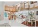 Expansive living room with soaring ceilings, an open floor plan, stairs, dining space, and plenty of natural light at 119 Carlyle Cir, Palm Harbor, FL 34683