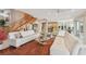 Bright living room showcasing a staircase, kitchen and dining areas, and an ocean view through large sliding glass doors at 119 Carlyle Cir, Palm Harbor, FL 34683