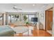 Bright main bedroom with water views from windows, a ceiling fan, and light hardwood floors at 119 Carlyle Cir, Palm Harbor, FL 34683