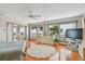 Bright main bedroom with water views from windows, a ceiling fan, and light hardwood floors at 119 Carlyle Cir, Palm Harbor, FL 34683
