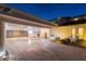 Wide porte cochere, brick driveway, and manicured landscaping at 119 Carlyle Cir, Palm Harbor, FL 34683