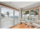 Bright sunroom with water views, a small table set, and sliding glass doors to the outdoor deck at 119 Carlyle Cir, Palm Harbor, FL 34683