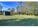 Large backyard with a shed and plenty of space for outdoor activities in a private, fenced area at 12102 Hazen Ave, Thonotosassa, FL 33592