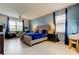 Spacious bedroom with a decorative wall, tufted headboard, and neutral colors at 12704 Palapa Loop, Spring Hill, FL 34610