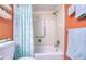 Well-maintained bathroom with shower over tub and safety handrail and sea-themed decor at 19029 Us Highway 19 N # 29E, Clearwater, FL 33764