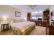 Comfortable bedroom featuring a ceiling fan, large bed, and built-in desk with bookshelves at 19029 Us Highway 19 N # 29E, Clearwater, FL 33764