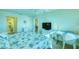 Cozy bedroom with calming beach themed comforter, a TV, and adjacent bathroom access at 19029 Us Highway 19 N # 29E, Clearwater, FL 33764