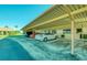 An exterior angle of covered parking featuring multiple spots for cars at 19029 Us Highway 19 N # 29E, Clearwater, FL 33764