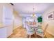 Bright dining area with a glass table, wicker chairs, and a view into the kitchen at 19029 Us Highway 19 N # 29E, Clearwater, FL 33764