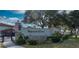 Inviting gated entrance to Imperial Cove, featuring lush landscaping and a decorative wall at 19029 Us Highway 19 N # 29E, Clearwater, FL 33764