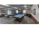 Game room featuring two billiards tables, with cues and seating, set in a well-lit space at 19029 Us Highway 19 N # 29E, Clearwater, FL 33764