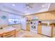 Bright kitchen featuring wooden cabinets, granite counters, and modern white appliances at 19029 Us Highway 19 N # 29E, Clearwater, FL 33764