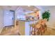 Kitchen featuring granite countertops, a breakfast bar, and an adjacent entry door at 19029 Us Highway 19 N # 29E, Clearwater, FL 33764