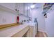 Functional laundry room with washer, dryer, and storage cabinets at 19029 Us Highway 19 N # 29E, Clearwater, FL 33764