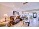 Comfortable living room with leather recliners, a water view, and access to the balcony at 19029 Us Highway 19 N # 29E, Clearwater, FL 33764