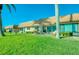 Back patio of home with green lawn and patio furniture at 19029 Us Highway 19 N # 29E, Clearwater, FL 33764