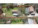 Aerial view of the property showcasing a large backyard, pool, and mature trees at 1975 Levine Ln, Clearwater, FL 33760