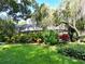 Lush backyard featuring a screened-in lanai, perfect for outdoor entertaining and enjoying the serene surroundings at 1975 Levine Ln, Clearwater, FL 33760