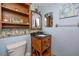 Bathroom featuring a sink with wood cabinet, marine-themed decor, and blue walls at 1975 Levine Ln, Clearwater, FL 33760