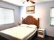 This bedroom features a ceiling fan, two windows, and a queen bed at 1975 Levine Ln, Clearwater, FL 33760