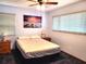 Cozy bedroom with carpet, ceiling fan and a serene sunset artwork at 1975 Levine Ln, Clearwater, FL 33760