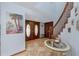 Welcoming foyer featuring tile flooring, staircase, and double doors leading to other parts of the home at 1975 Levine Ln, Clearwater, FL 33760