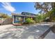 Charming blue two-story home with well-maintained landscaping, and a spacious driveway at 1975 Levine Ln, Clearwater, FL 33760