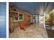 Inviting front porch with a swing, brick accents, tile flooring, and a welcoming atmosphere at 1975 Levine Ln, Clearwater, FL 33760