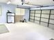 Spacious garage with mini-refrigerator, and fitness rower on a freshly painted floor at 1975 Levine Ln, Clearwater, FL 33760