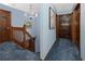 Upstairs hallway with staircase, chandelier, and blue walls at 1975 Levine Ln, Clearwater, FL 33760