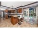 Modern kitchen with stainless appliances, granite countertops, and island seating, overlooking the pool at 1975 Levine Ln, Clearwater, FL 33760