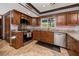 Well-equipped kitchen with granite countertops, stainless steel appliances, and wooden cabinetry at 1975 Levine Ln, Clearwater, FL 33760