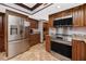 Spacious kitchen with stainless steel appliances and warm, wood cabinetry throughout at 1975 Levine Ln, Clearwater, FL 33760