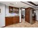 Kitchen with wood cabinetry, granite countertops, and stainless steel refrigerator at 1975 Levine Ln, Clearwater, FL 33760