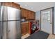 Laundry area with stainless steel refrigerator, red washer and dryer, sink, and plenty of cabinets at 1975 Levine Ln, Clearwater, FL 33760